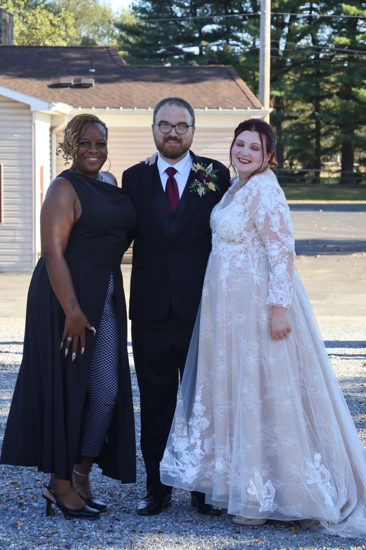 Kesha standing with Stacey and Joseph on their wedding day