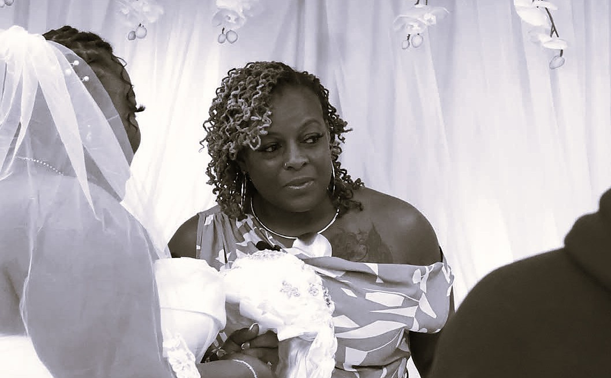 Kesha officiating a ceremony as the bride looks on