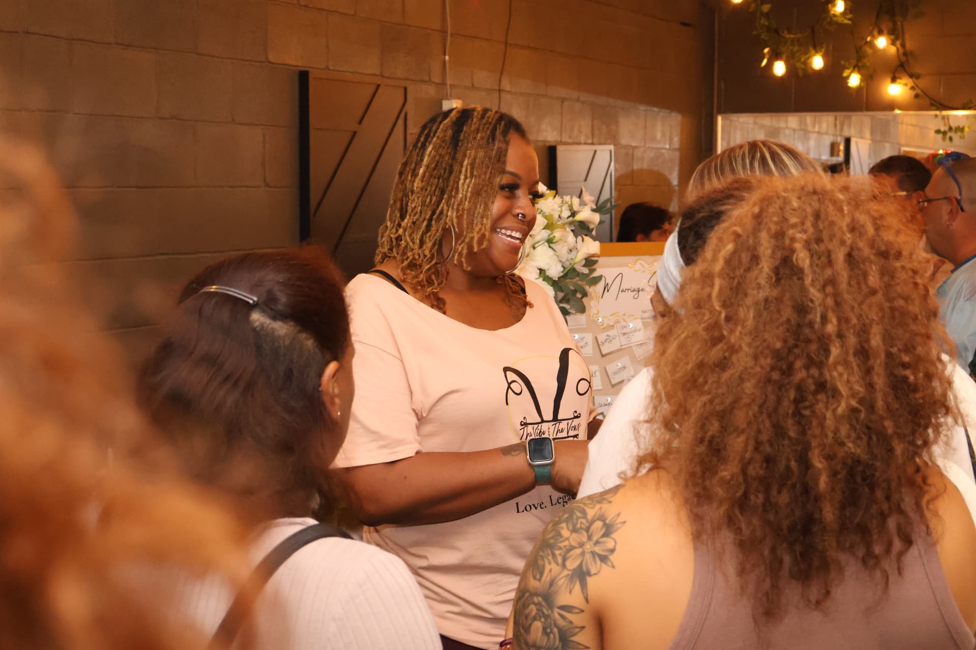 Kesha smiling while speaking with guests about wedding ceremonies