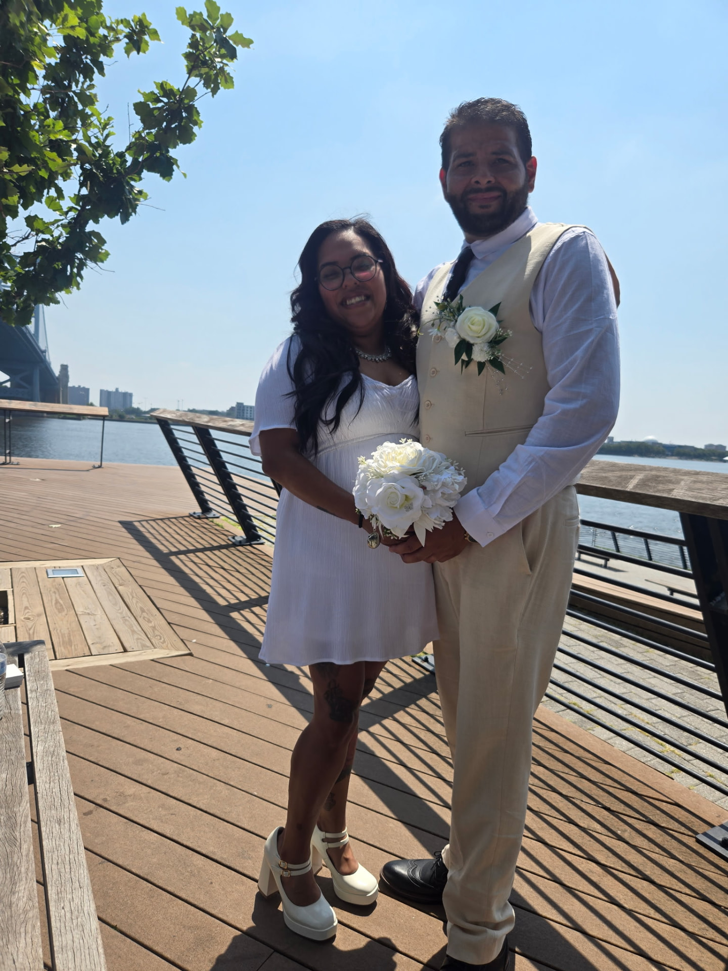Jocelyn and her husband standing together at Race Street Pier after their ceremony
