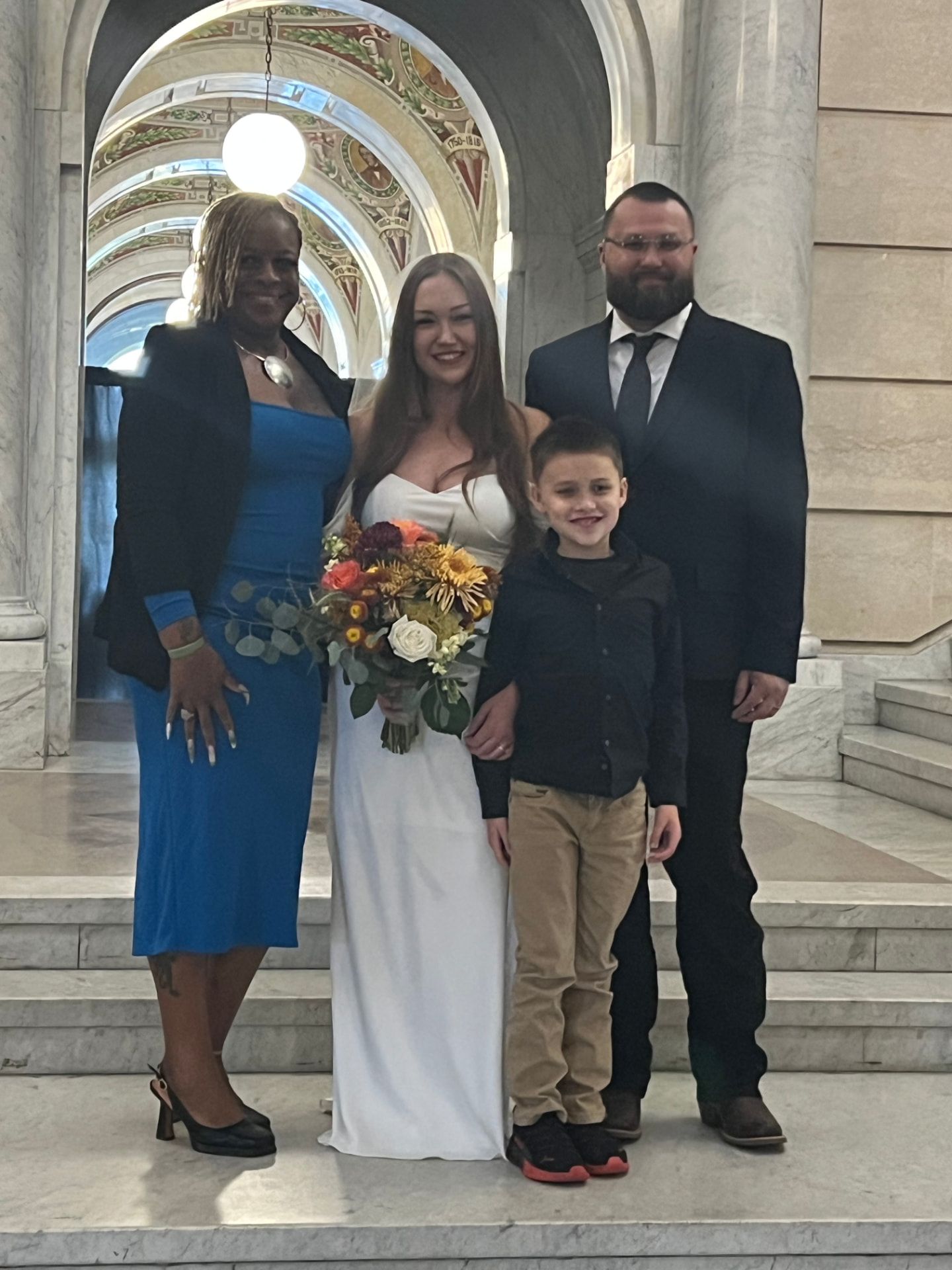 Kesha standing with Kelly, her husband, and their son after the wedding ceremony