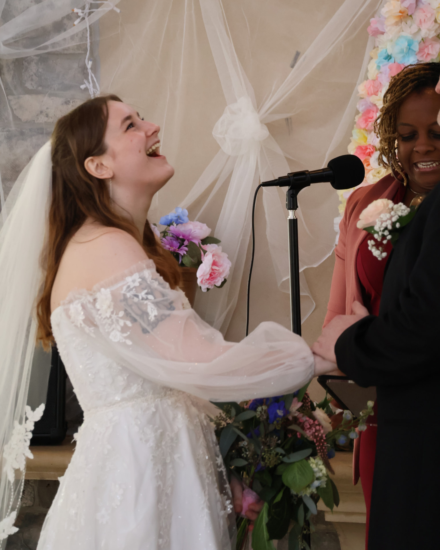 Bride laughing mid-ceremony as Kesha officiates